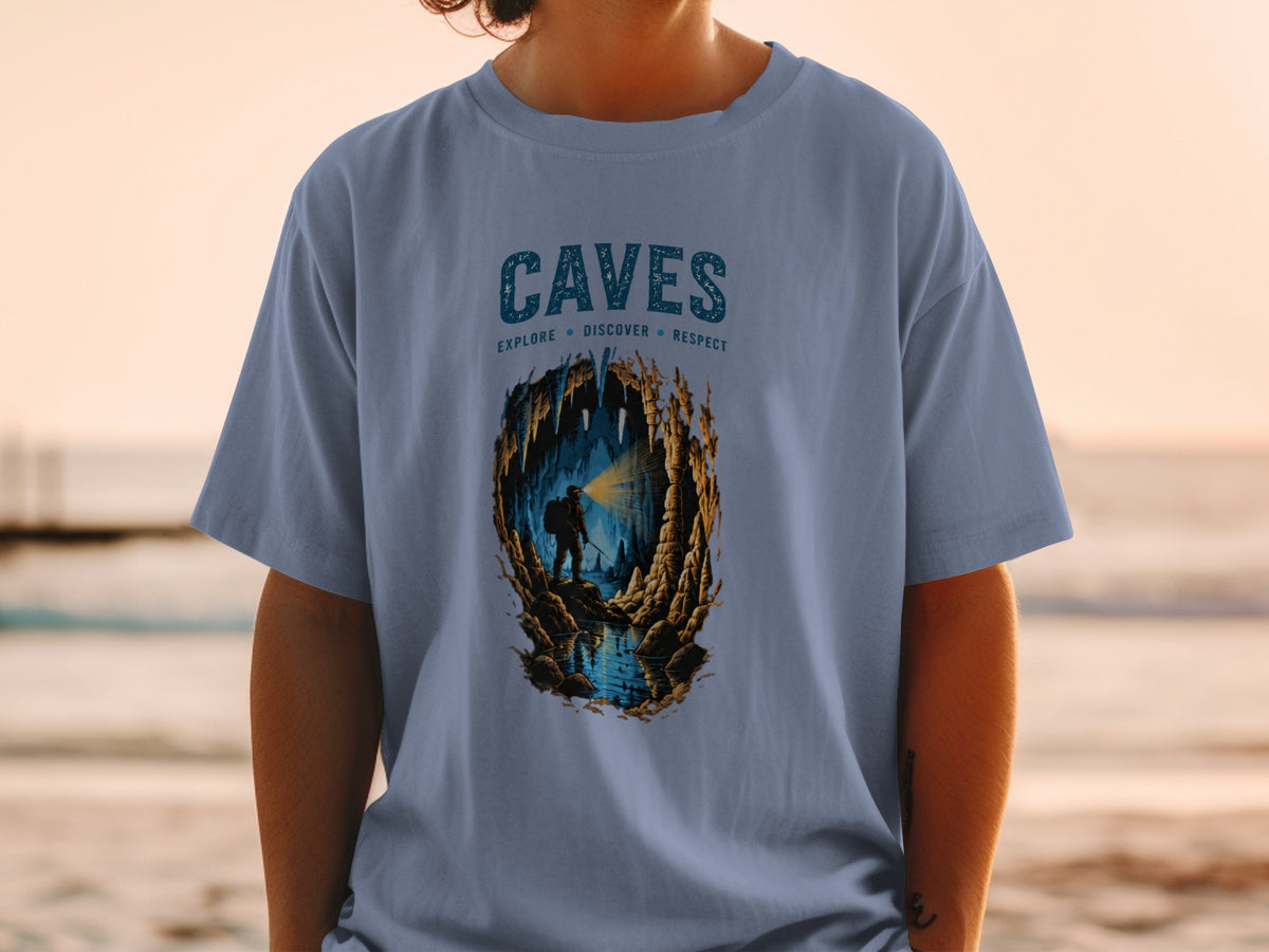 Blue t-shirt with "CAVES EXPLORE DISCOVER RESPECT" text and cave explorer illustration.