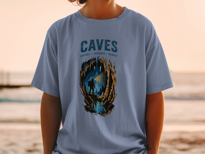Blue t-shirt with "CAVES EXPLORE DISCOVER RESPECT" text and cave explorer illustration.
