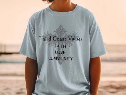 Light blue t-shirt with "Third Coast Values", "FAITH", "LOVE", "COMMUNITY" text and a cross.