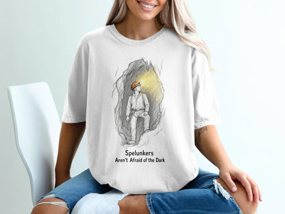 White t-shirt with graphic of spelunker in cave, text "Spelunkers Aren't Afraid of the Dark".