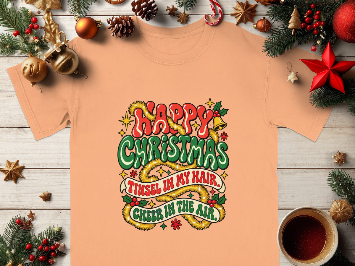 Peach t-shirt with "Happy Christmas" and "Tinsel in my hair, Cheer in the air."