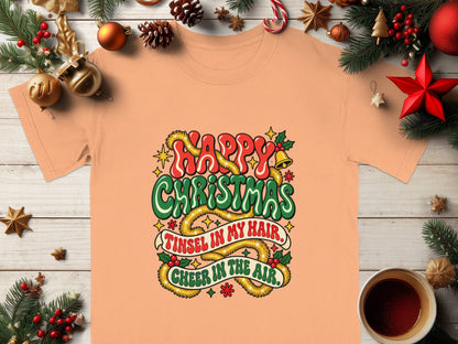 Peach t-shirt with "Happy Christmas" and "Tinsel in my hair, Cheer in the air."