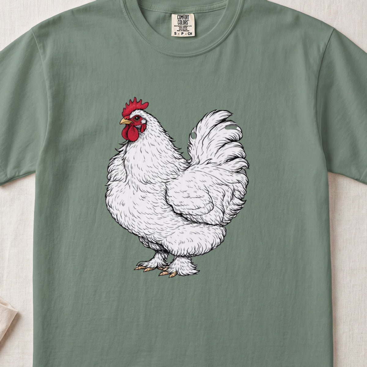 Green crewneck t-shirt featuring a detailed white rooster illustration centered on the chest.