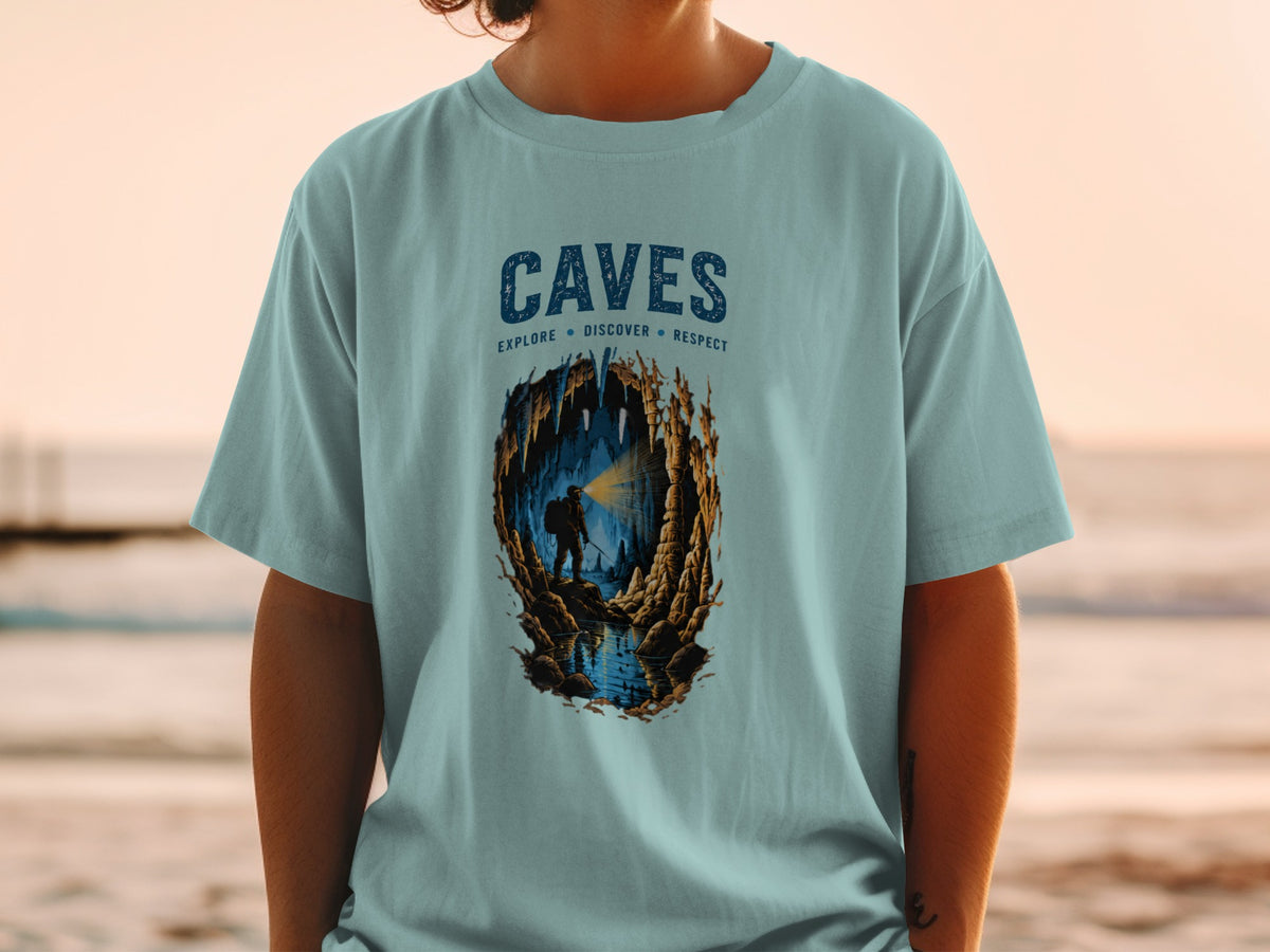 Light blue t-shirt with "CAVES EXPLORE DISCOVER RESPECT" graphic of a caver.