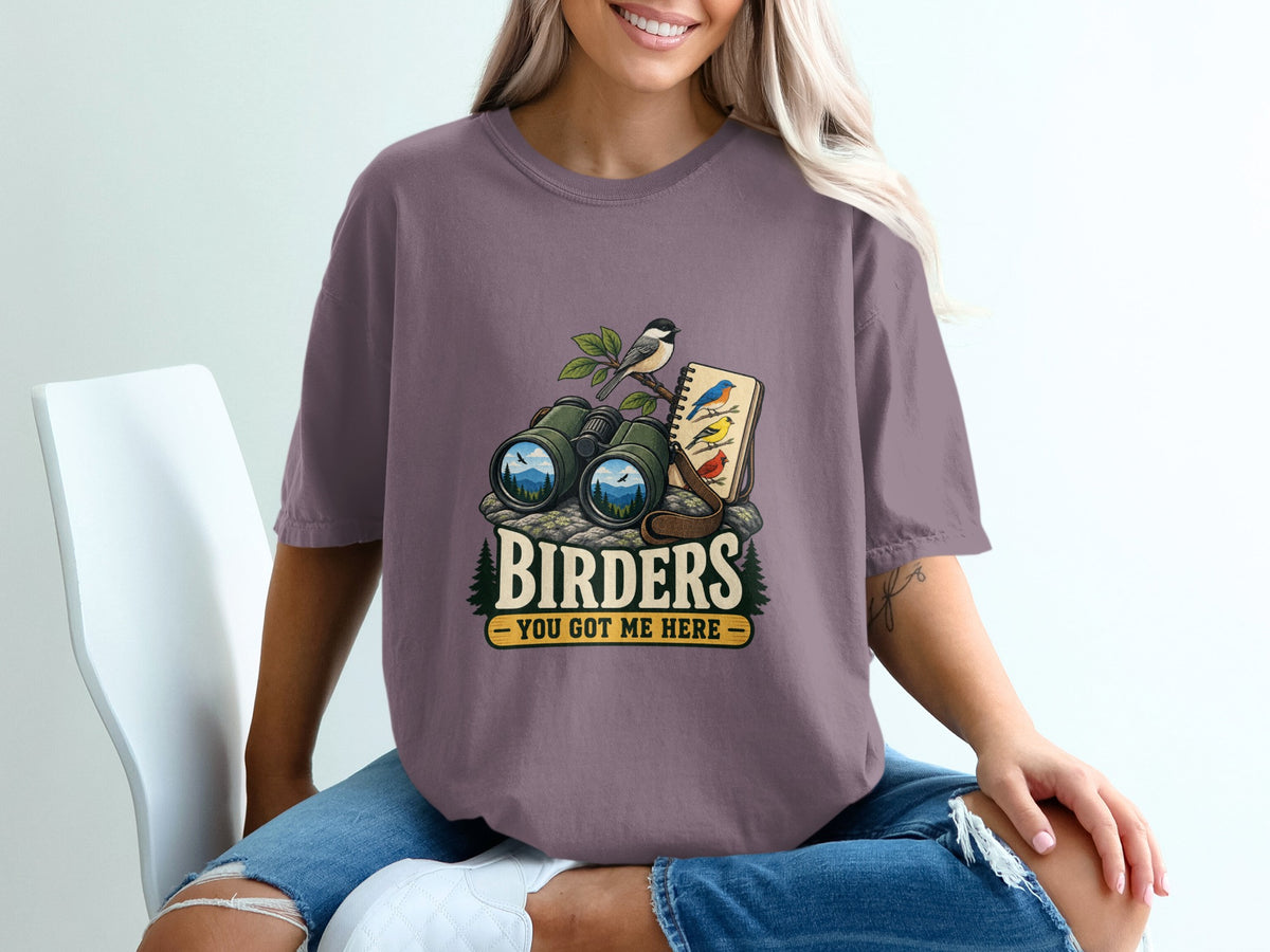 Binoculars and notebook with birds, text "BIRDERS YOU GOT ME HERE".