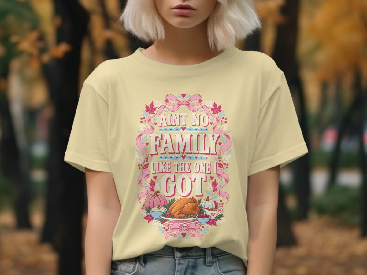 Yellow t-shirt with "Ain't no family like the one I got" text and Thanksgiving food illustration.