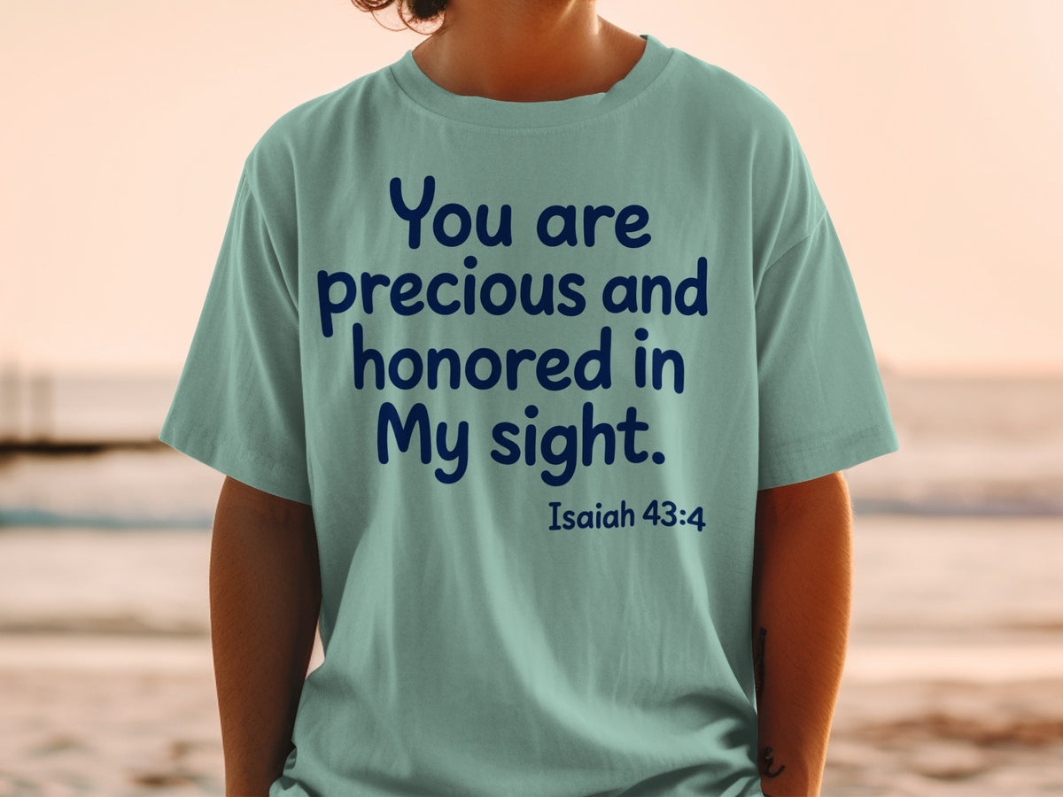 Light teal t-shirt with dark blue text: "You are precious and honored in My sight. Isaiah 43:4."