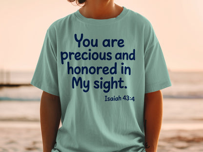 Light teal t-shirt with dark blue text: "You are precious and honored in My sight. Isaiah 43:4."