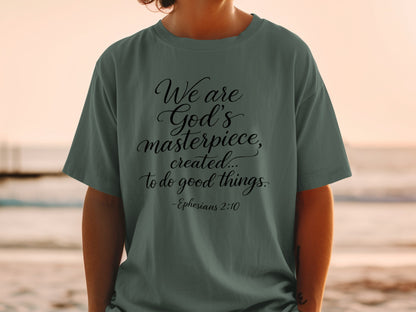 Green t-shirt with black text reading "We are God's masterpiece, created... to do good things. -Ephesians 2:10"
