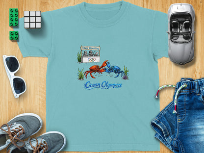 T-shirt graphic features red and blue crabs wrestling with "Ocean Olympics" text.