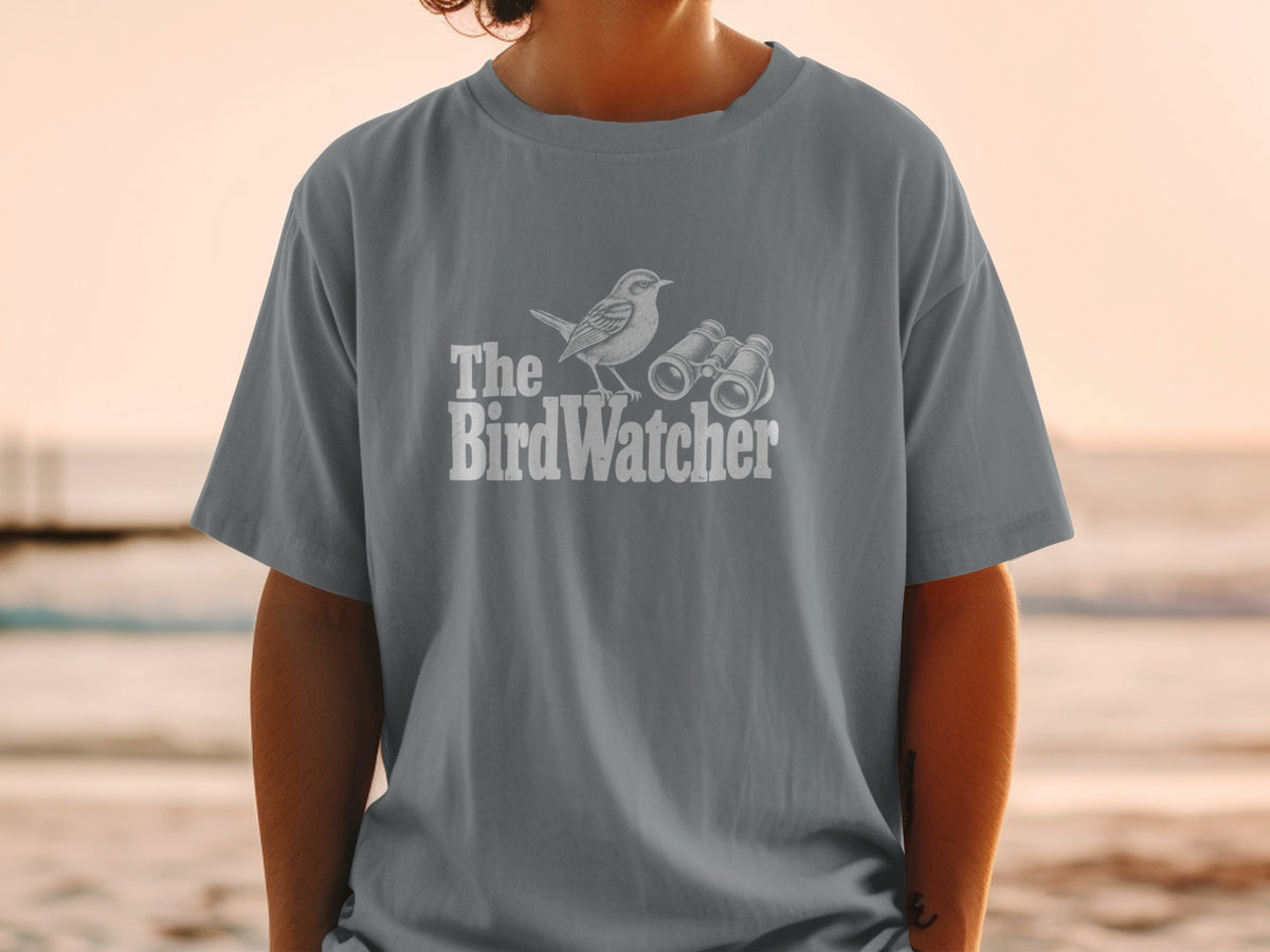 T-shirt with white graphic of a bird and binoculars, text reads "The BirdWatcher."