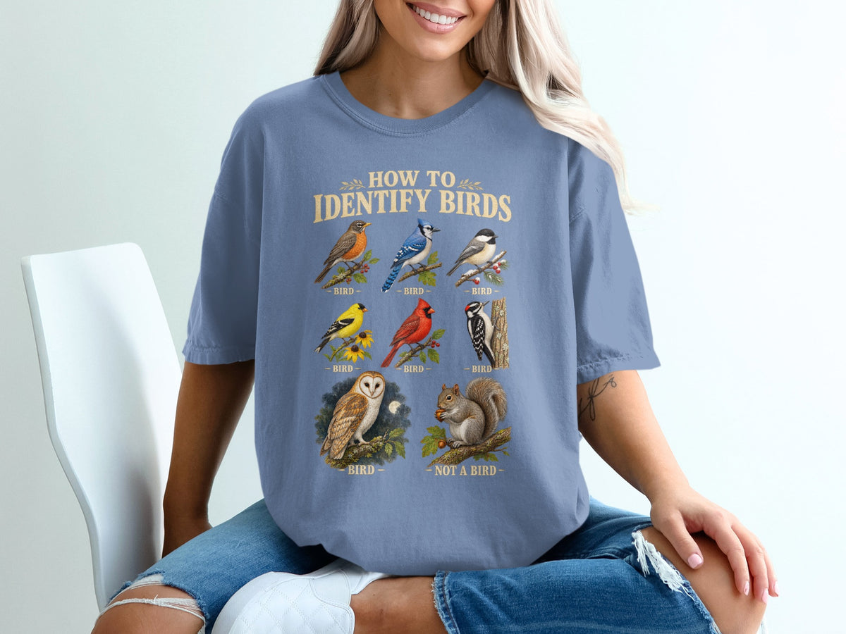 T-shirt with "How to Identify Birds" text and illustrations of various birds and a squirrel.