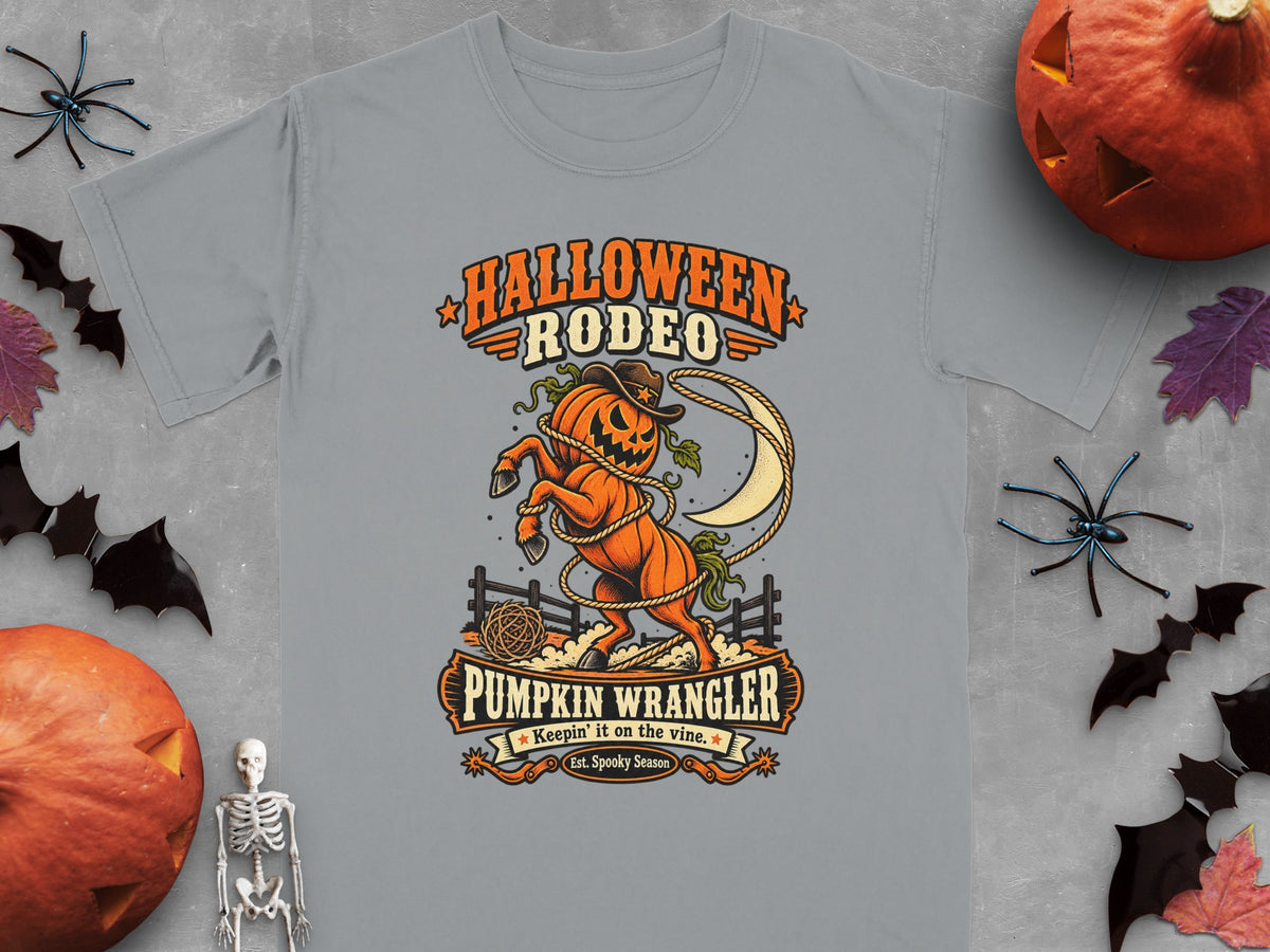 Gray t-shirt with Halloween Rodeo design: pumpkin horse, moon, lasso, fence, and text.