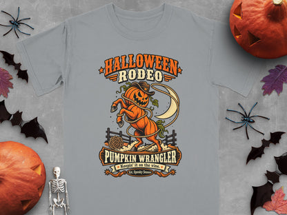 Gray t-shirt with Halloween Rodeo design: pumpkin horse, moon, lasso, fence, and text.