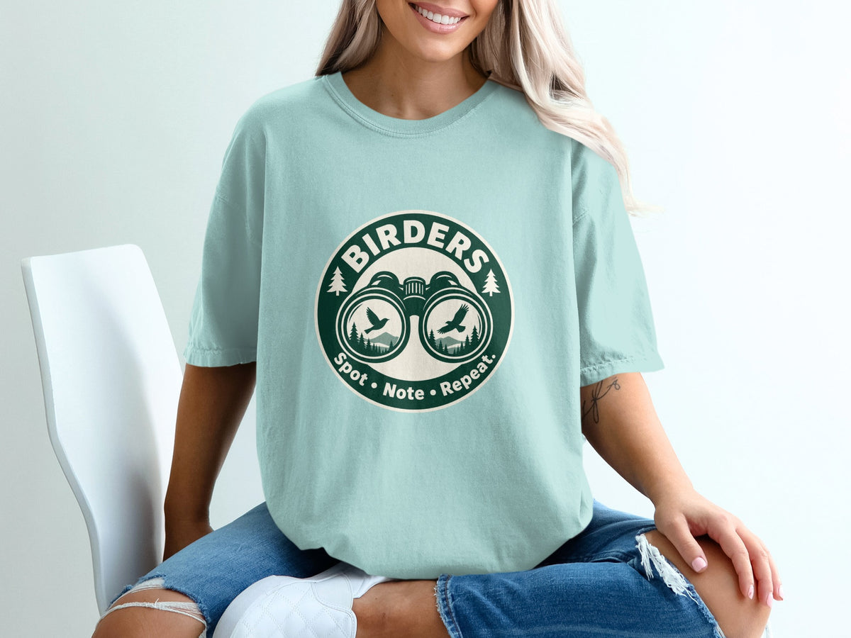 Light blue t-shirt with "Birders Spot • Note • Repeat." and binoculars graphic.