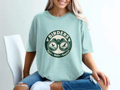 Light blue t-shirt with "Birders Spot • Note • Repeat." and binoculars graphic.