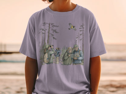 Birdwatching illustration on a purple t-shirt with people and a bird in a forest.