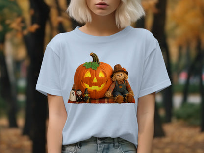 Light blue t-shirt with a Halloween graphic featuring a jack-o'-lantern, scarecrow, and small spooky characters.