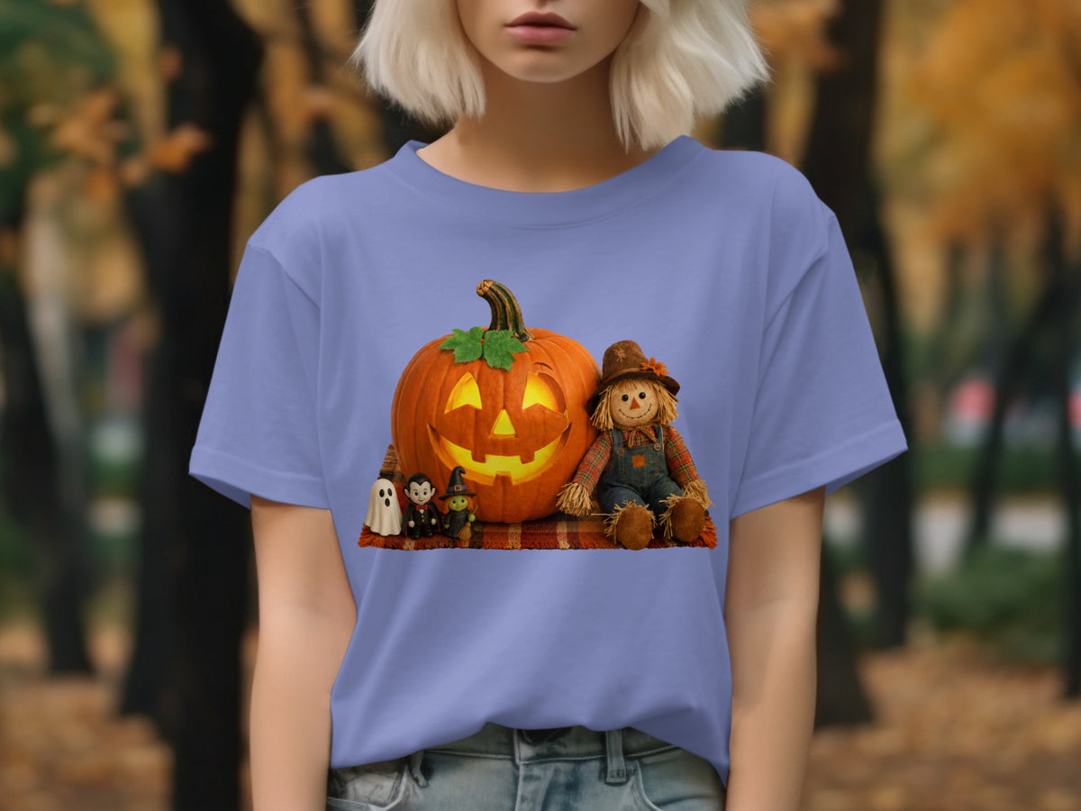 Pumpkin, scarecrow, and spooky figures Halloween graphic on a light purple t-shirt.
