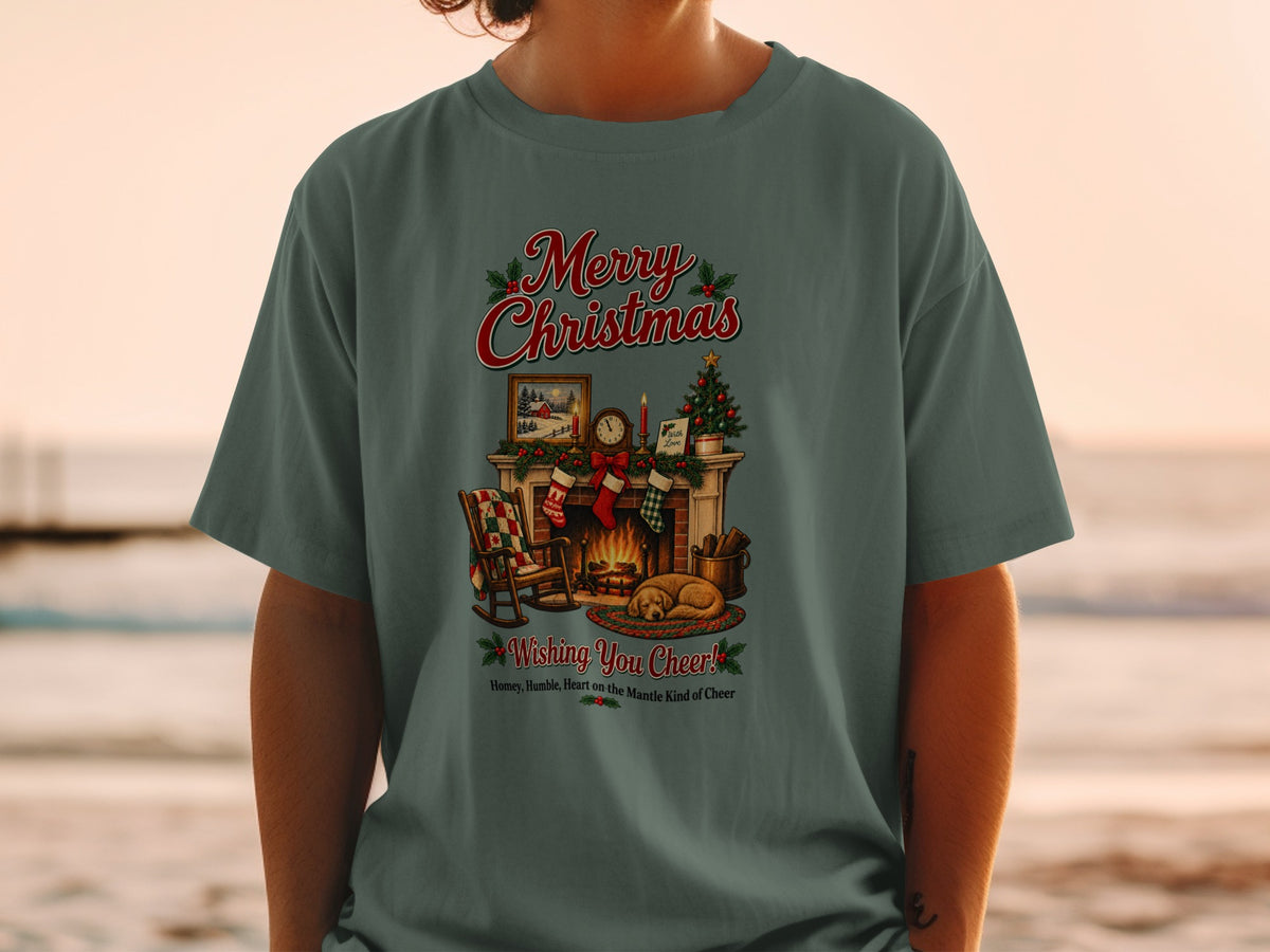 T-shirt with a Christmas fireplace scene, stockings, tree, and text.