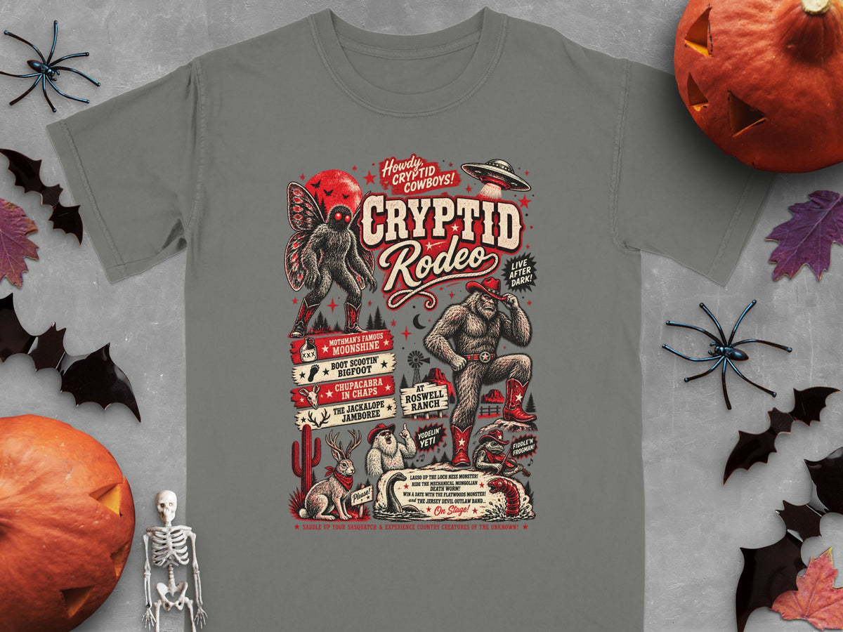 Gray t-shirt with Cryptid Rodeo graphic featuring Bigfoot, Mothman, Chupacabra, and UFO.
