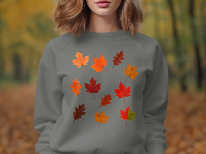 Grey sweatshirt with scattered autumn leaf pattern on chest.