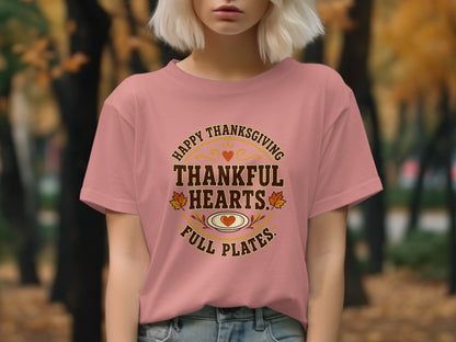 Pink t-shirt with "Happy Thanksgiving Thankful Hearts Full Plates" text and Thanksgiving graphics.