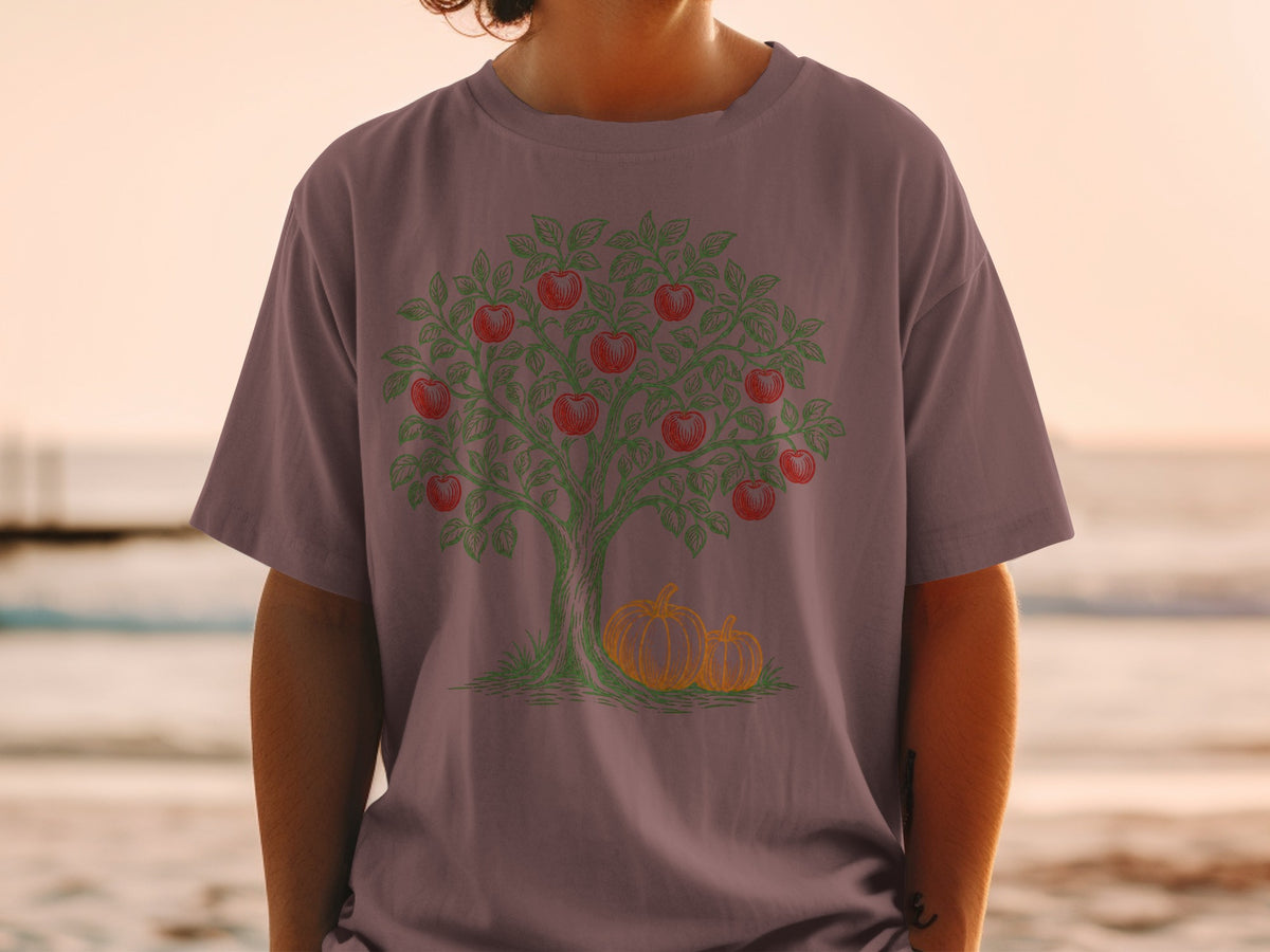 T-shirt with illustration of apple tree with two pumpkins at its base.