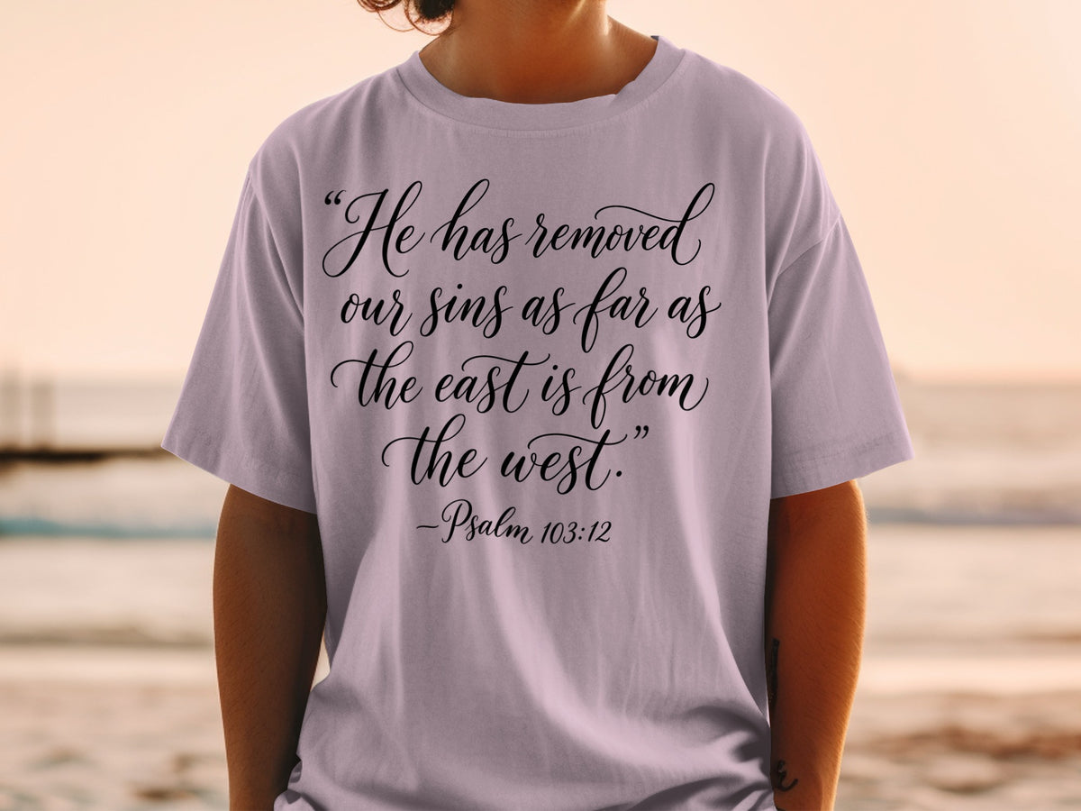 Light purple t-shirt with black script reading "He has removed our sins as far as the east is from the west." - Psalm 103:12