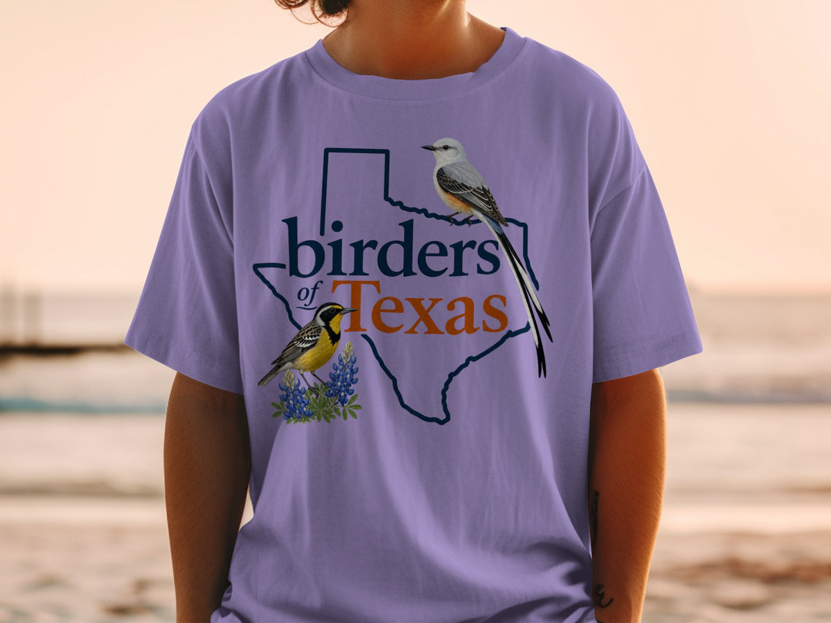 Purple t-shirt with outline of Texas and birds, text "birders of Texas".