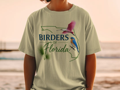 T-shirt with outline of Florida, roseate spoonbill, bluebird, and text.