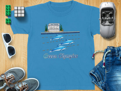Blue t-shirt with cartoon dolphins racing and text "Ocean Olympics".