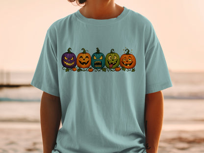 T-shirt with a row of five cartoon Halloween pumpkins with unique facial expressions.