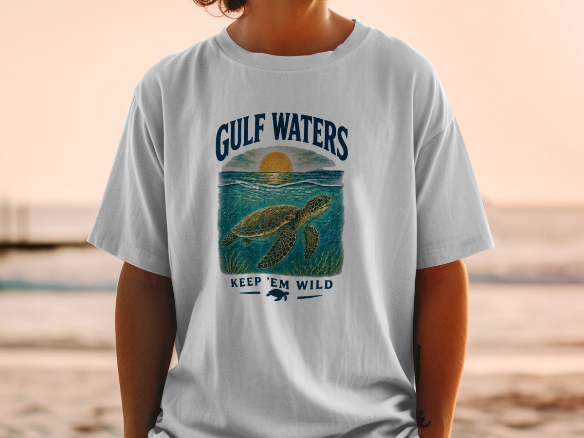 White t-shirt with Gulf Waters design featuring a sea turtle and sunset.