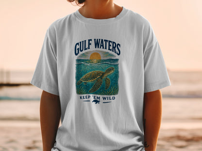 White t-shirt with Gulf Waters design featuring a sea turtle and sunset.