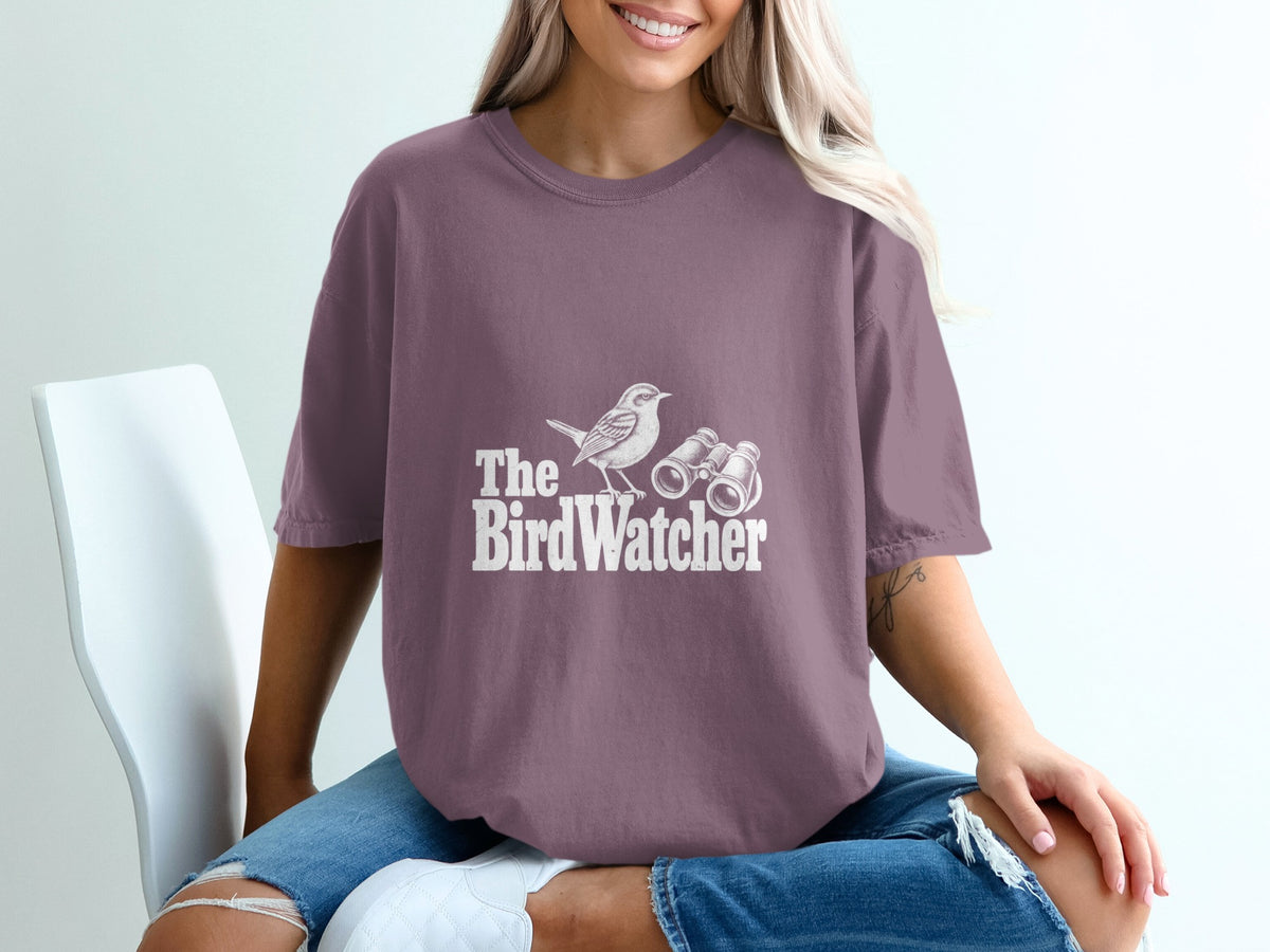 T-shirt with white text "The BirdWatcher" and graphic of a bird and binoculars.
