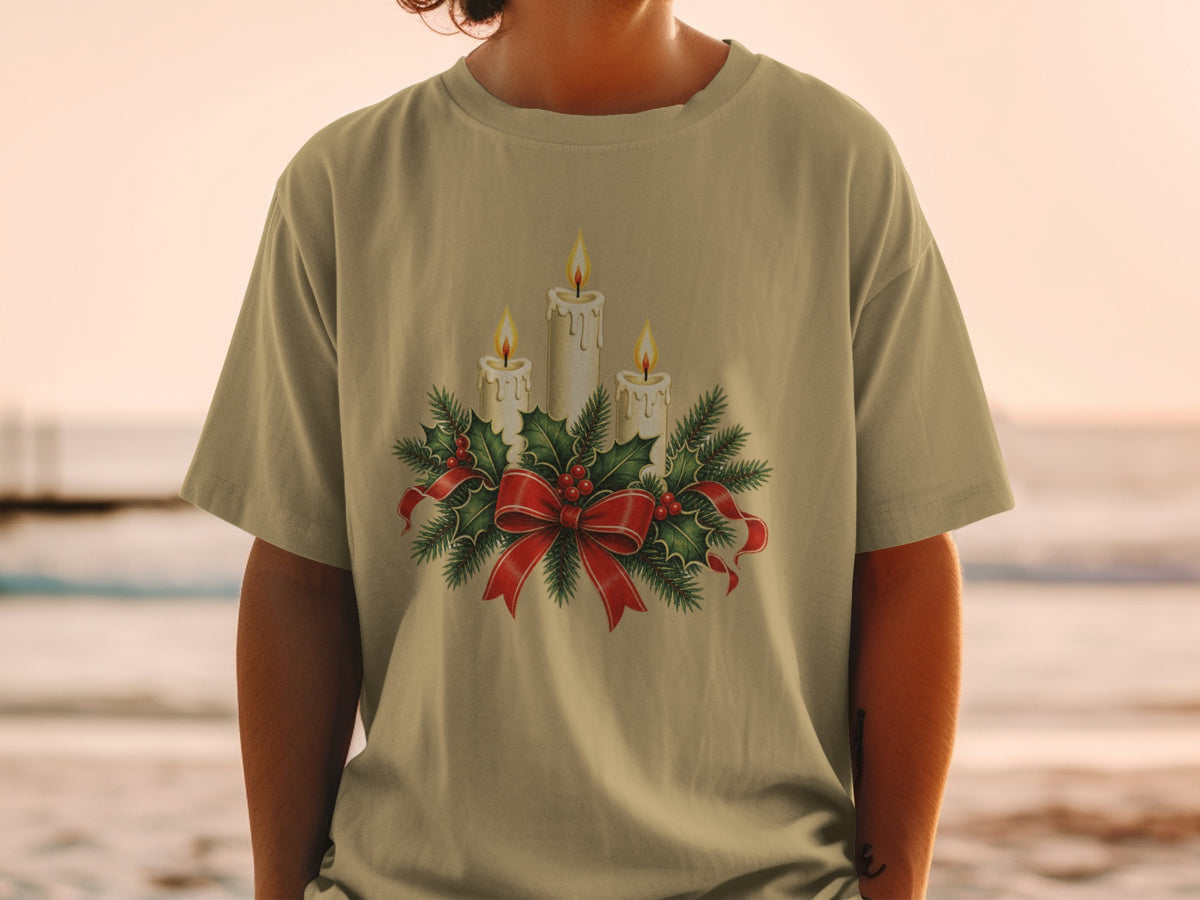 T-shirt with Christmas candle arrangement and red ribbon graphic.
