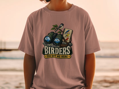 Binoculars, birds, and a notebook with "Birders - You Got Me Here" text.