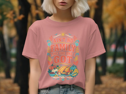Pink t-shirt with "Ain't No Family Like The One I Got" text and a Thanksgiving feast.