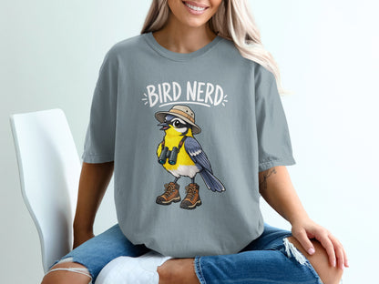 Gray t-shirt with "BIRD NERD" text and illustration of a bird with binoculars and hiking boots.