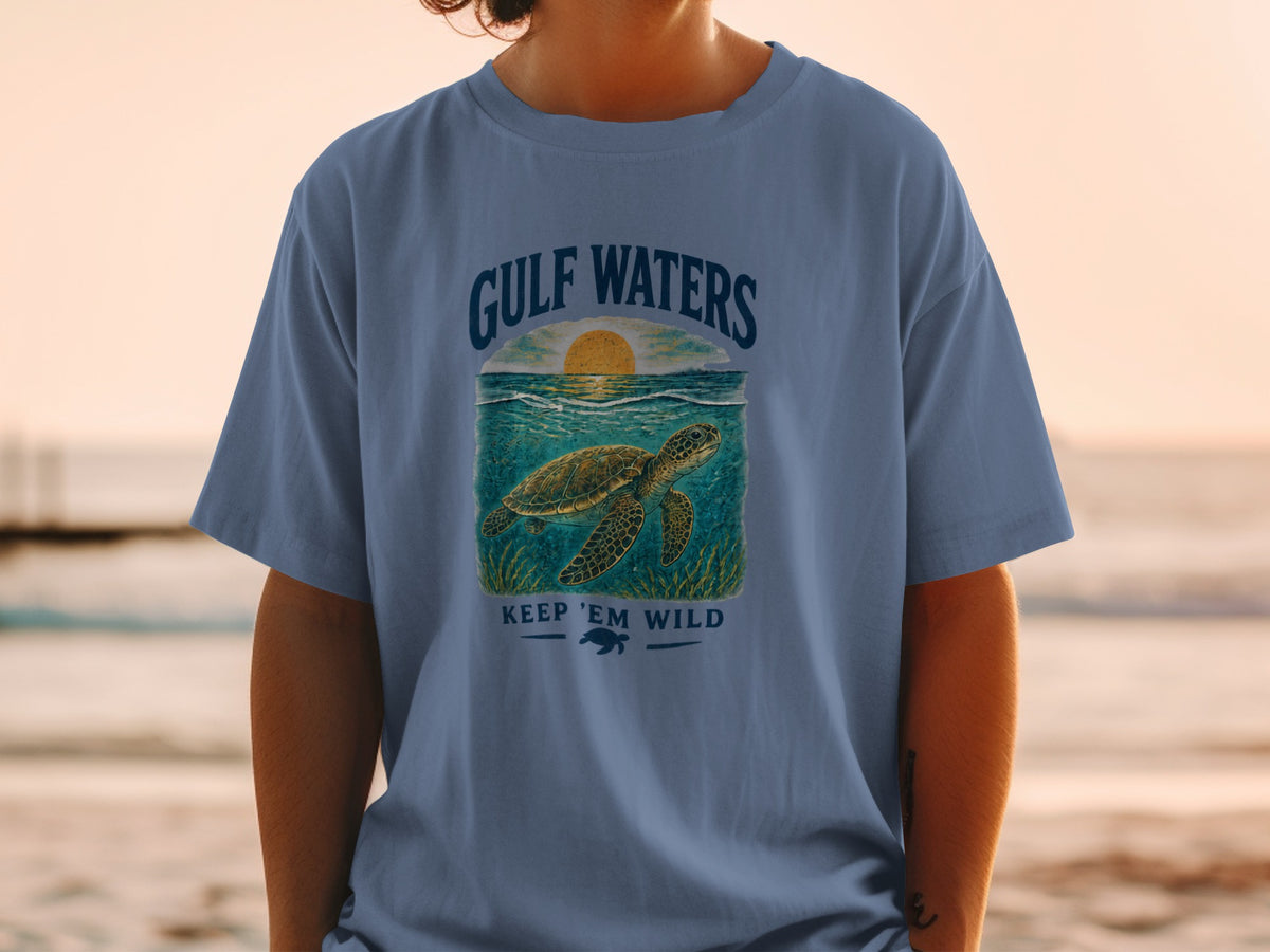 Blue t-shirt with sea turtle graphic and text "Gulf Waters Keep 'Em Wild".
