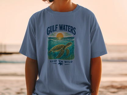 Blue t-shirt with sea turtle graphic and text "Gulf Waters Keep 'Em Wild".