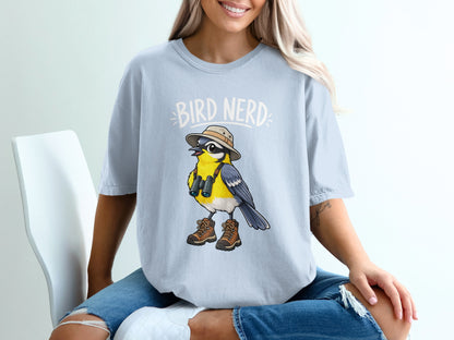 Light blue t-shirt with cartoon bird wearing hat, binoculars, and boots, with "Bird Nerd" text.