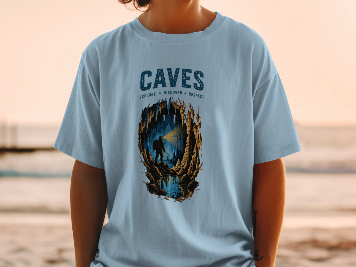 Light blue t-shirt with "CAVES EXPLORE DISCOVER RESPECT" graphic and cave explorer.