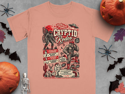 T-shirt with Cryptid Rodeo theme, featuring Bigfoot, Mothman, UFO, and other creatures.