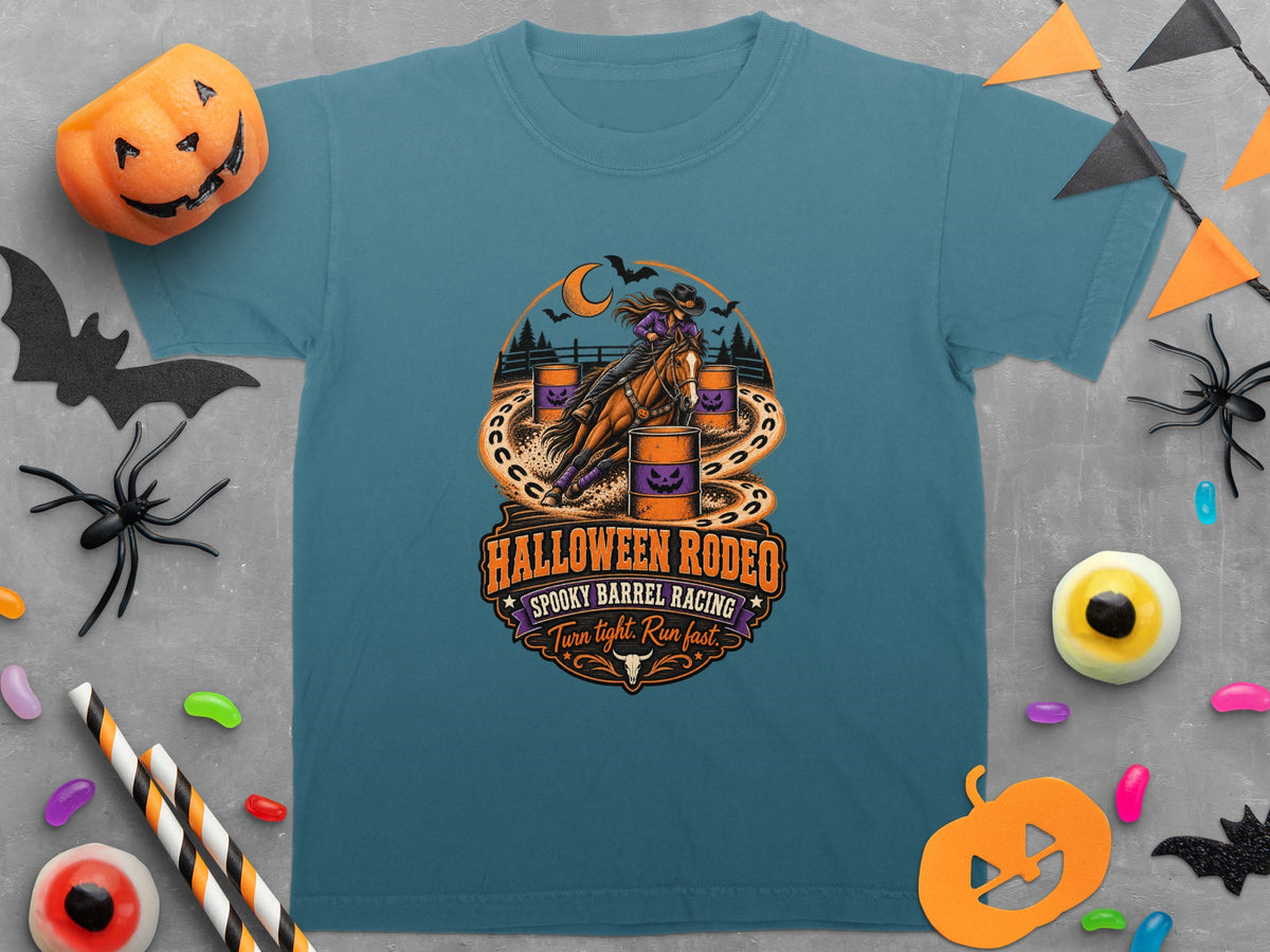 Teal t-shirt with Halloween Rodeo graphic of barrel racing with pumpkins and moon.