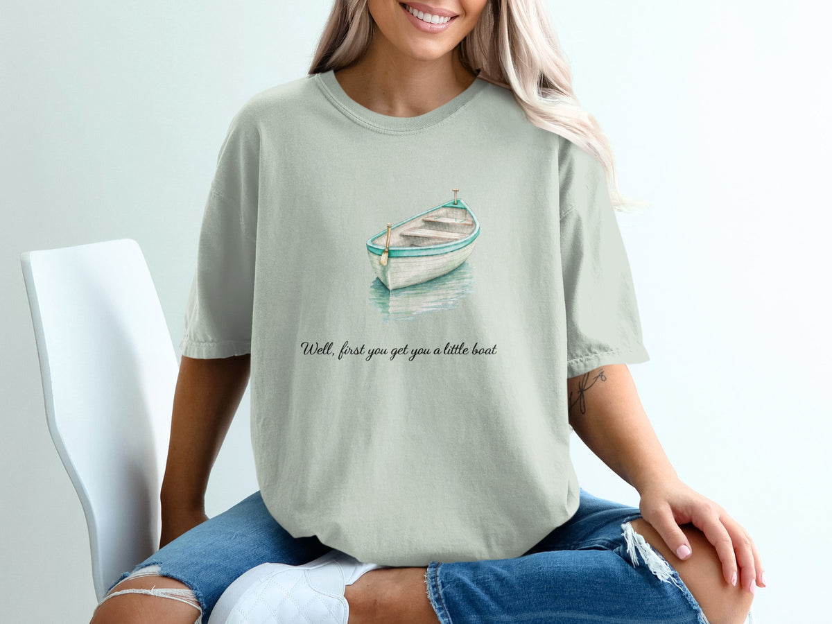 T-shirt with watercolor boat graphic and text "Well, first you get you a little boat."