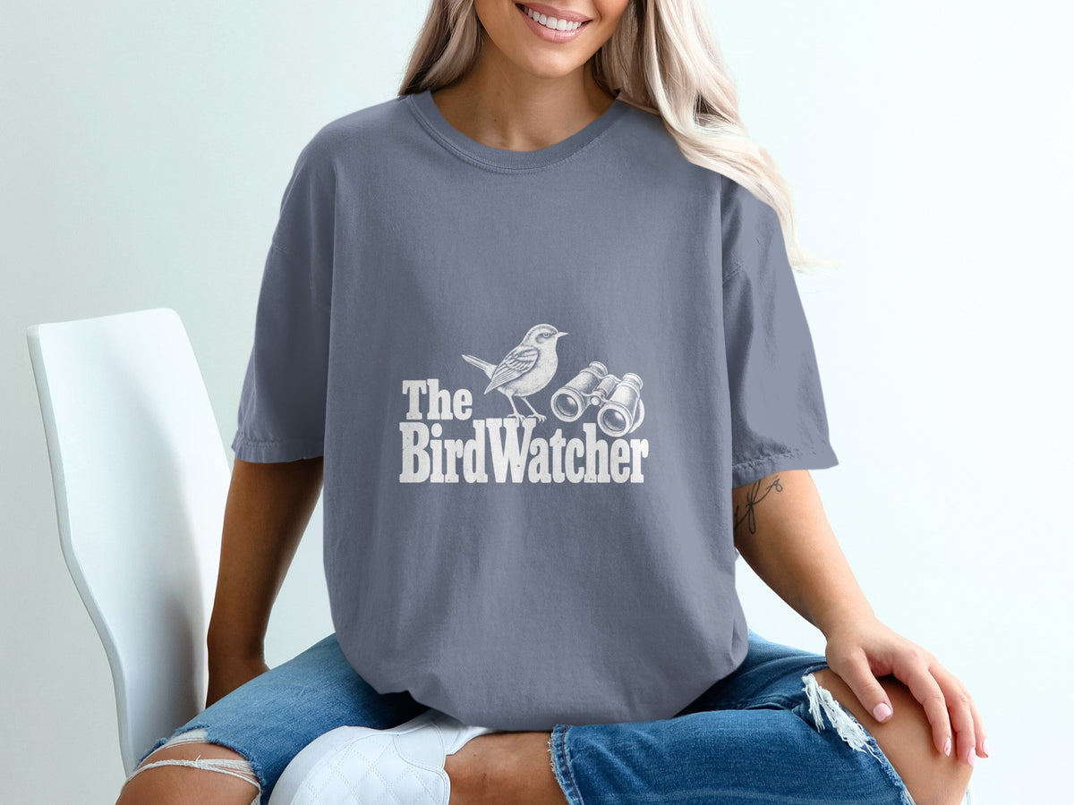 Gray t-shirt with white graphic of a bird and binoculars, and text "The BirdWatcher".