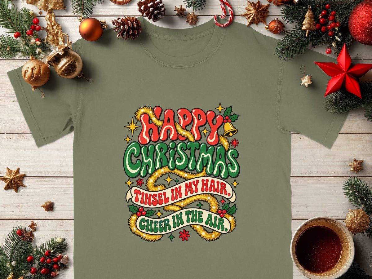 Green t-shirt with "Happy Christmas, Tinsel in my hair, Cheer in the air." text.