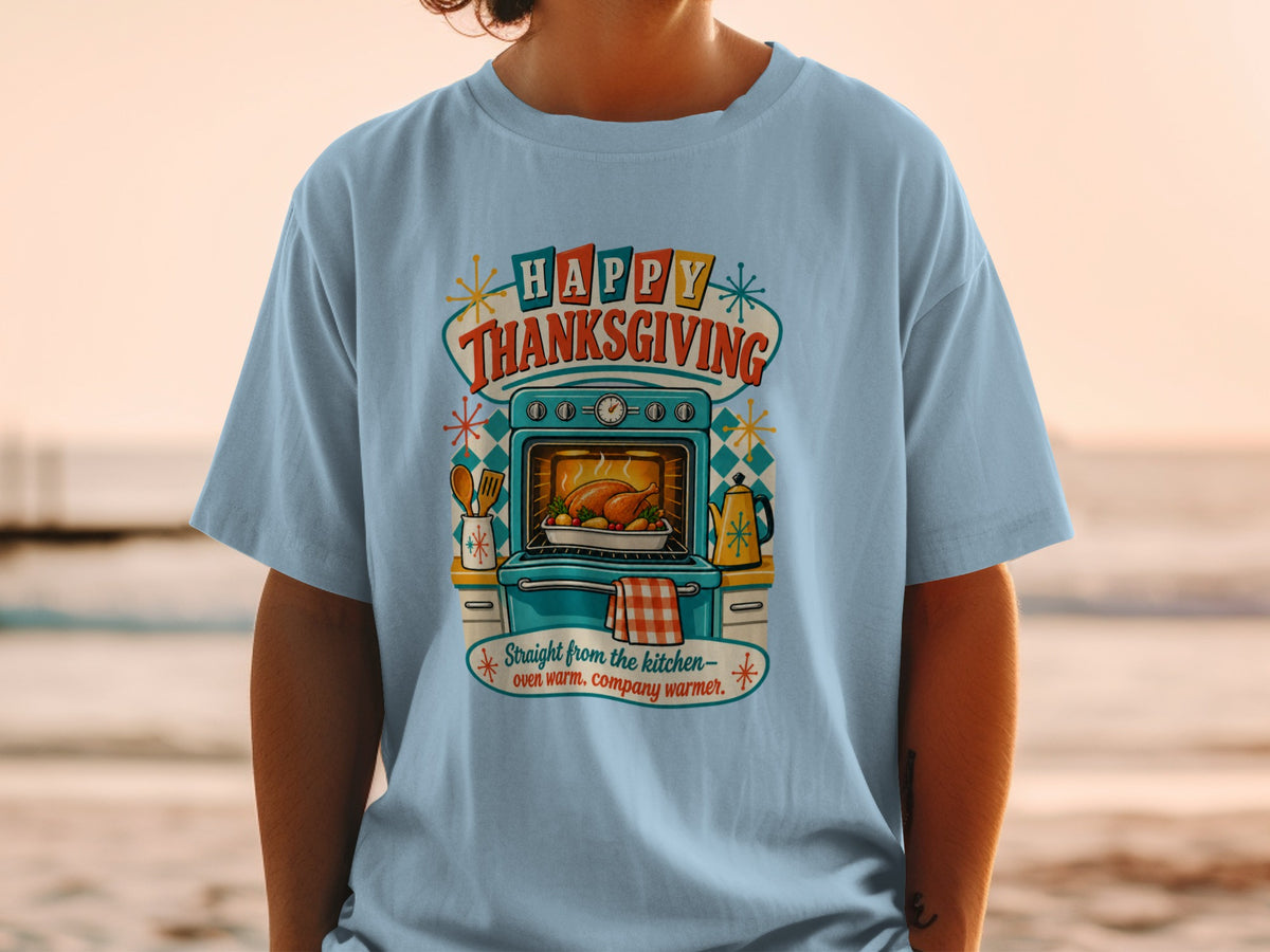 Light blue t-shirt with "Happy Thanksgiving" text, oven with turkey, and kitchen items.